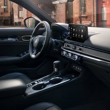 2027 Honda Civic Sedan Sport Touring Hybrid dashboard and center console view parked on a city street (Compact Sedan)